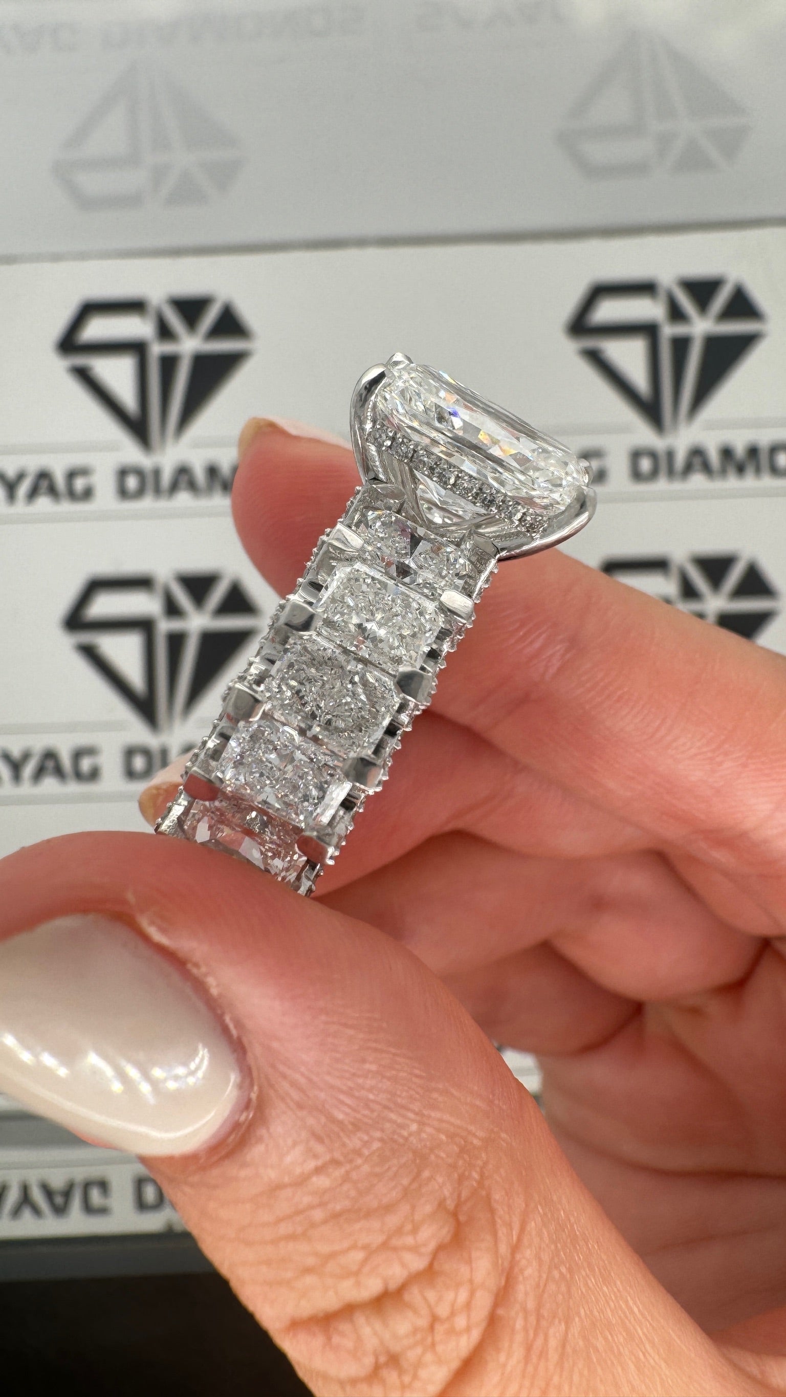 11 carat diamonds ,center diamond: 5 carat radiant shape side stones : –  sayag diamonds