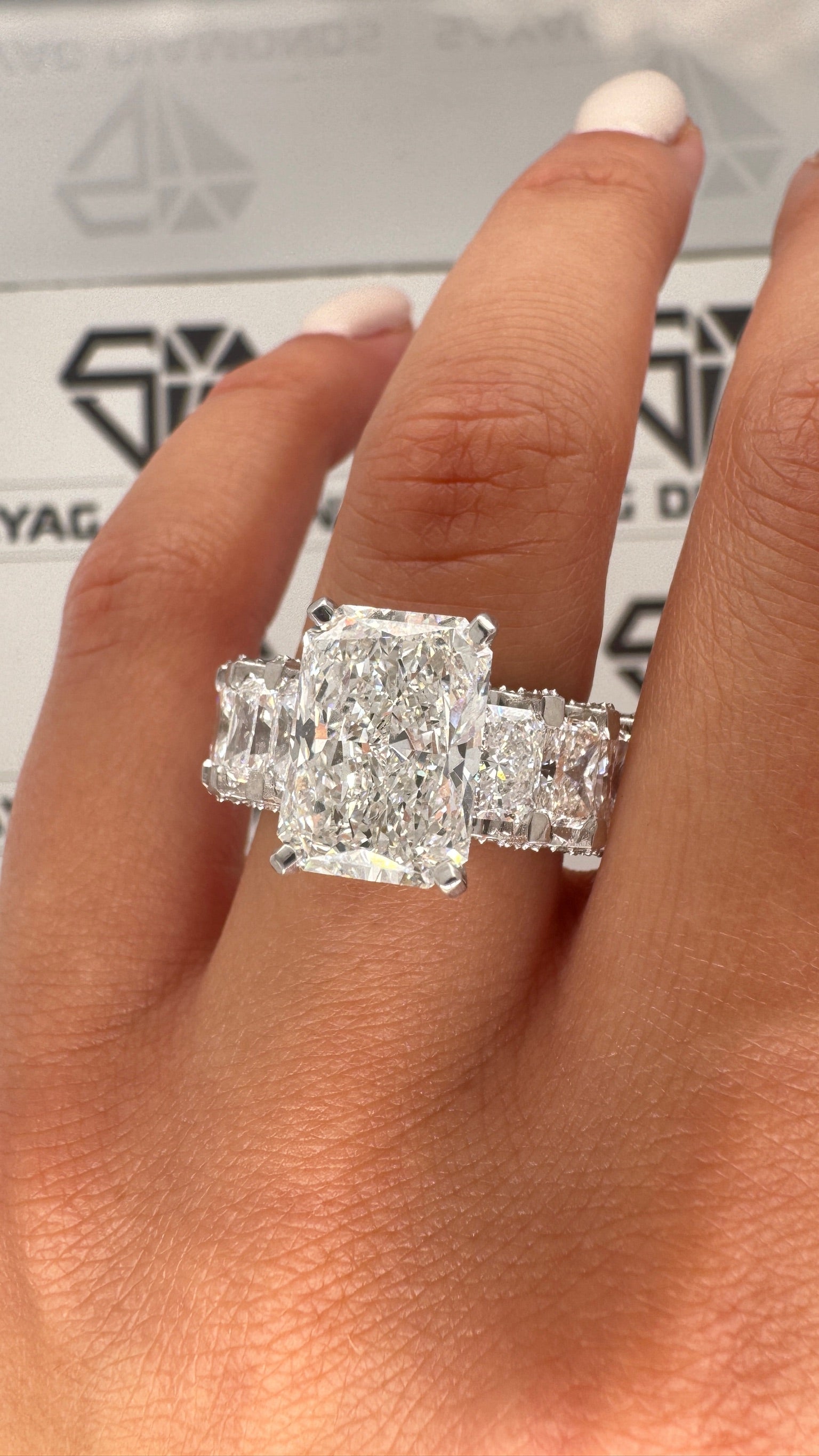 11 carat diamonds ,center diamond: 5 carat radiant shape side stones : –  sayag diamonds